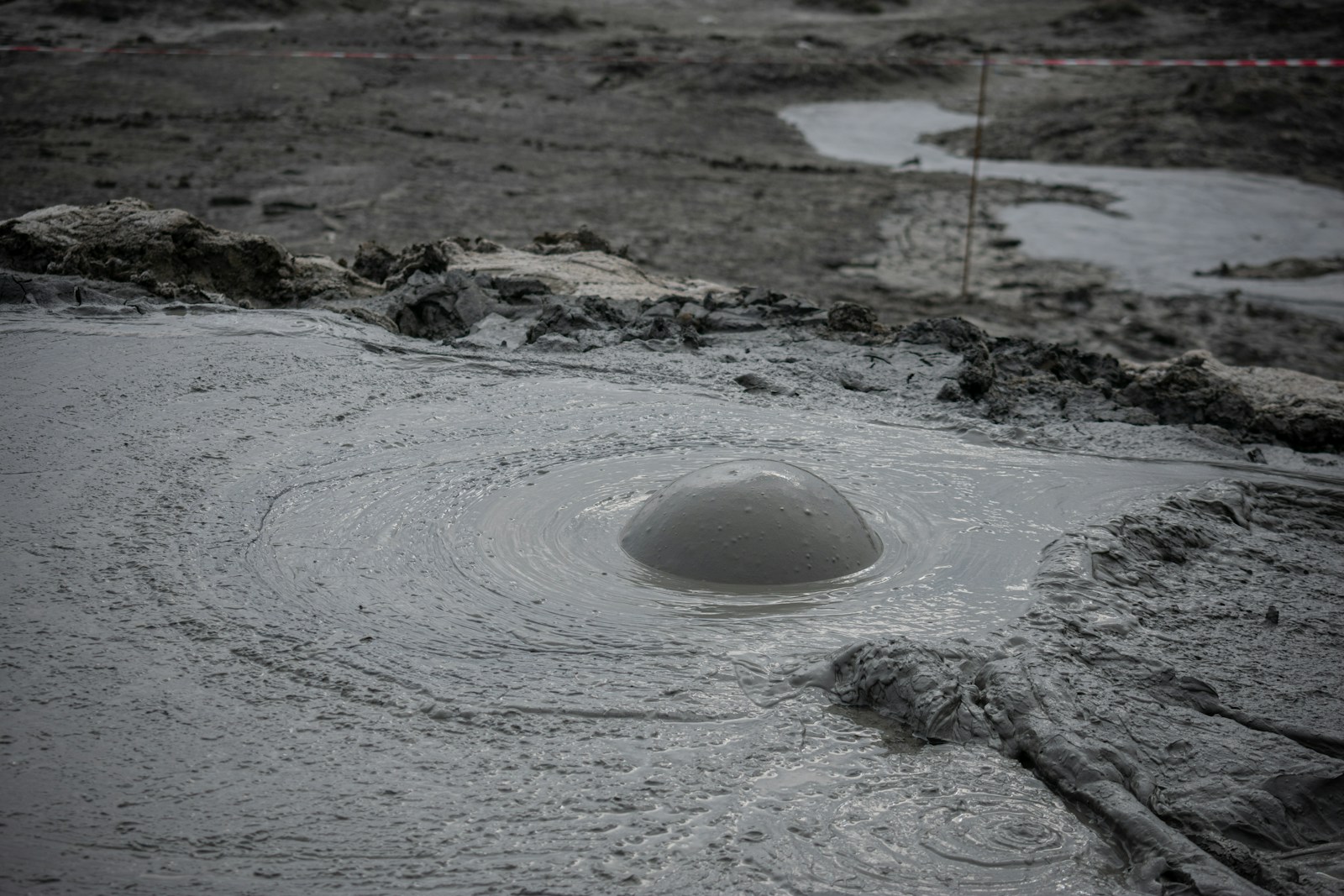 a hole in the ground with water coming out of it